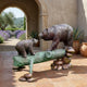 Large Traditional Bear and Cub Bronze Sculpture by Giant Sculptures on a tiled terrace, adult bear and cub facing across a verdigris log on river stones.