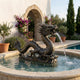 Large Traditional Chinese Dragon Bronze Fountain by Giant Sculptures, 150cm, spouting water from a wave-form base into a round stone pool by a poolside garden.