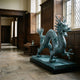 Large Traditional Chinese Dragon Bronze Sculpture by Giant Sculptures in turquoise verdigris, displayed on a black plinth in a wood-panelled hall with leaded windows.