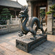 Giant Sculptures Large Traditional Chinese Dragon Bronze Sculpture 220cm in dark patina on a carved plinth, displayed in a traditional courtyard entrance.