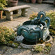 Giant Sculptures Large Traditional Coiling East Asian Dragon Bronze Fountain 120cm with verdigris patina coiled around a stone basin on a garden patio.