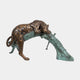 Large Traditional Crouching Leopard Bronze Sculpture by Giant Sculptures, draped over a verdigris log base with warm brown spotted patina, on a plain background.