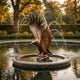 Giant Sculptures Large Traditional Diving Eagle Bronze Fountain 220cm with wings raised, water arcing from wingtips into a circular stone basin in a garden.