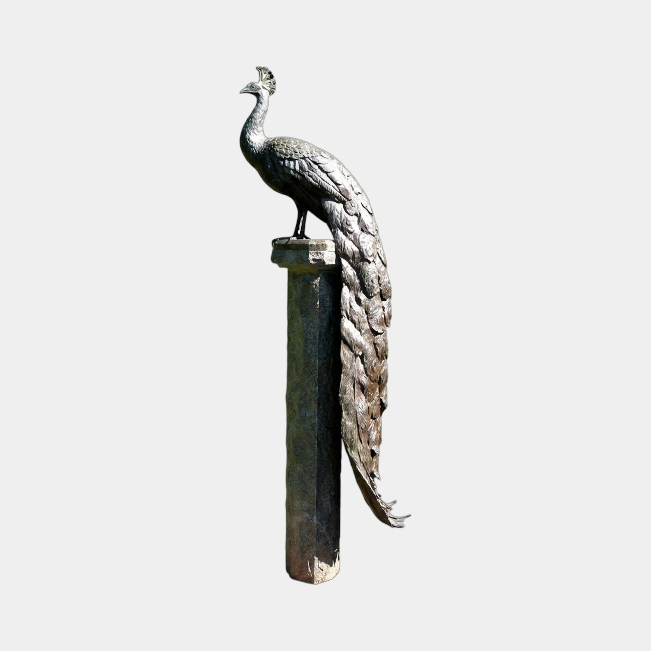 Large Traditional Peacock Bronze Sculpture by Giant Sculptures, 250cm, perched on a tall stone column with tail feathers cascading down its length.
