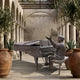 Large Traditional Pianist Bronze Sculpture by Giant Sculptures, 180cm seated figure at a grand piano with raised hand, displayed in a stone arched courtyard.