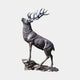 Large Traditional Rearing Stag Bronze Sculpture by Giant Sculptures, dark patina stag with raised head and full antlers on a rocky base, plain light background.