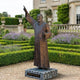 Giant Sculptures' 210cm Large Traditional Robed Figure Bronze Sculpture on a stone plinth, right arm raised skyward and left hand holding a cross, in a formal garden.