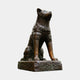 Large Traditional Seated Akita Dog Bronze Sculpture by Giant Sculptures, shown seated upright with head tilted skyward on a rocky base against a plain background.