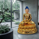 Large Traditional Seated Buddha Bronze Sculpture by Giant Sculptures in gold finish with blue ushnisha, on a double-lotus throne in a concrete room beside a garden.