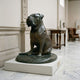 Giant Sculptures Large Traditional Seated Bulldog Bronze Sculpture, 100cm, dark patina with green oxidation, on an oval base displayed on a plinth in a marble gallery.