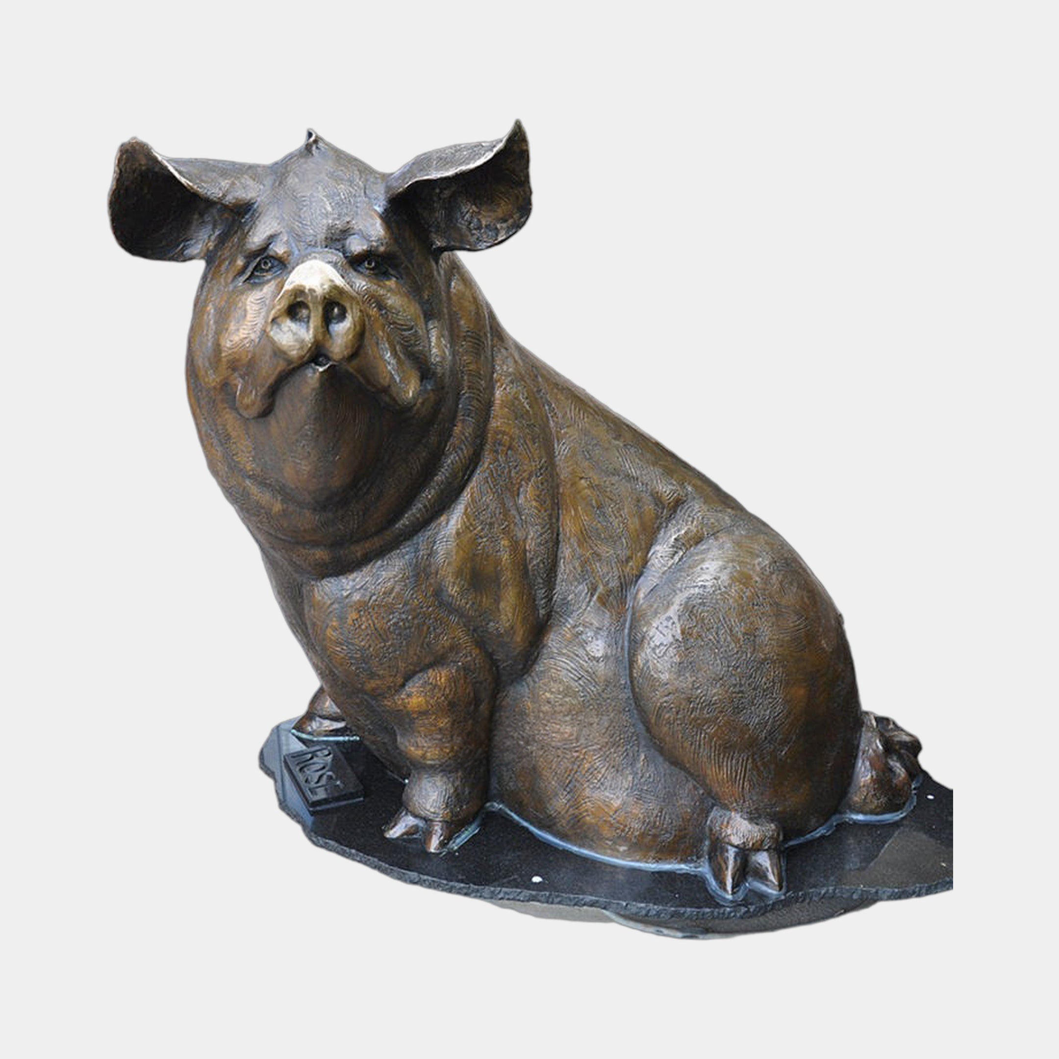 Large Traditional Seated Pig Bronze Sculpture by Giant Sculptures, shown front-on in warm brown patina, seated upright on a dark oval base with name plaque.