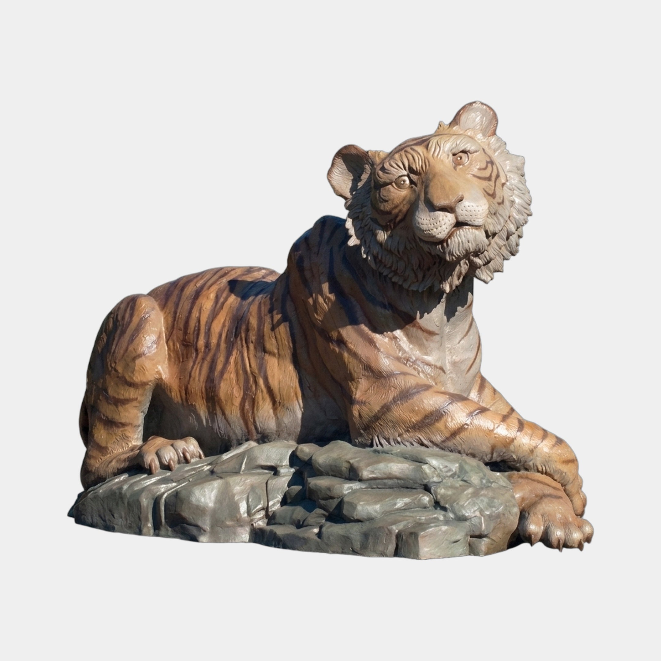 Large Traditional Seated Tiger Bronze Sculpture by Giant Sculptures in polychrome orange and black, reclining on a grey rocky base, shown against a plain background.