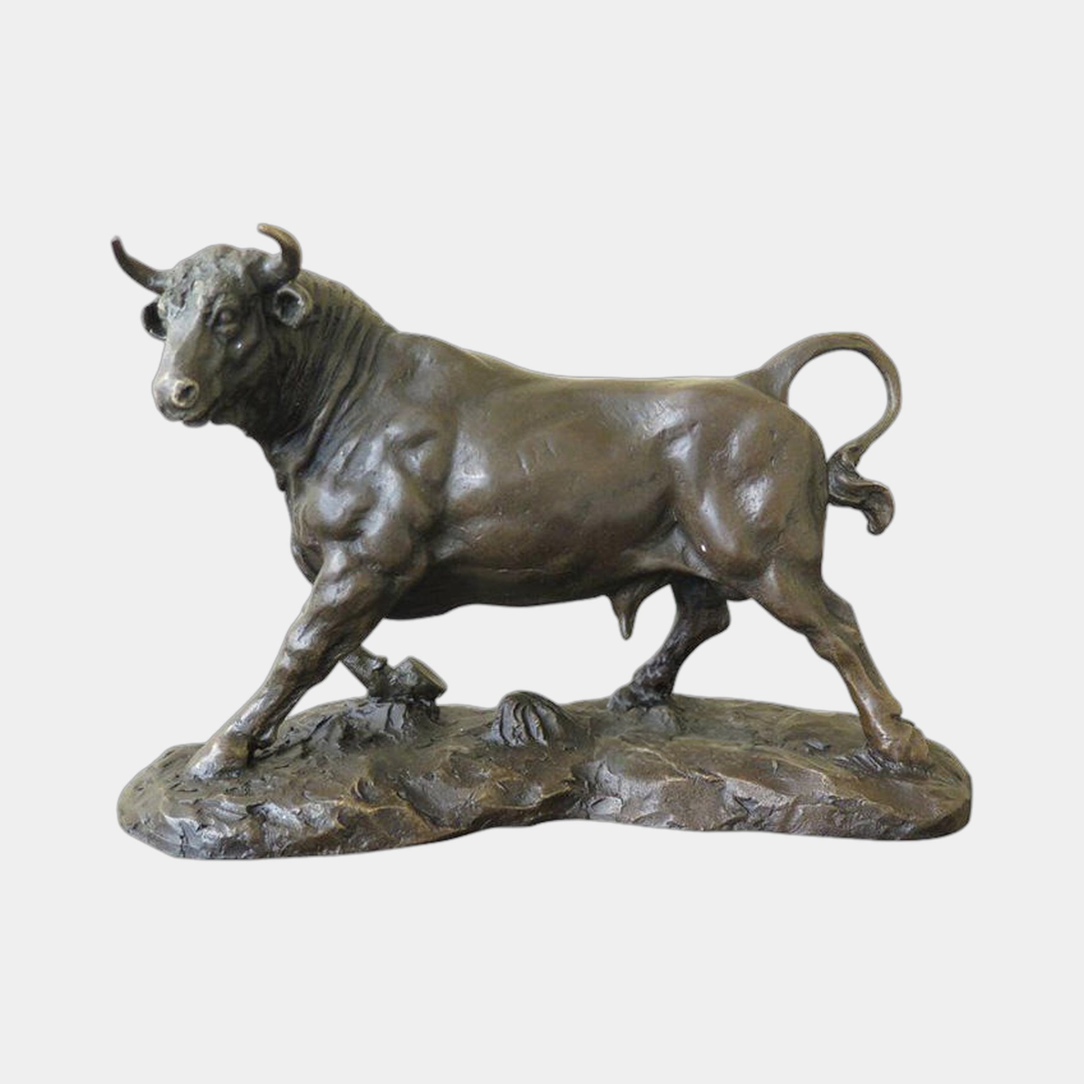 Large Traditional Striding Bull Bronze Sculpture by Giant Sculptures, shown in side profile with lowered head and curled tail on a naturalistic rocky base.