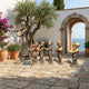 Giant Sculptures Large Traditional Violinist and Children Bronze Sculpture 200cm displayed on a Mediterranean stone terrace with olive tree and sea view.