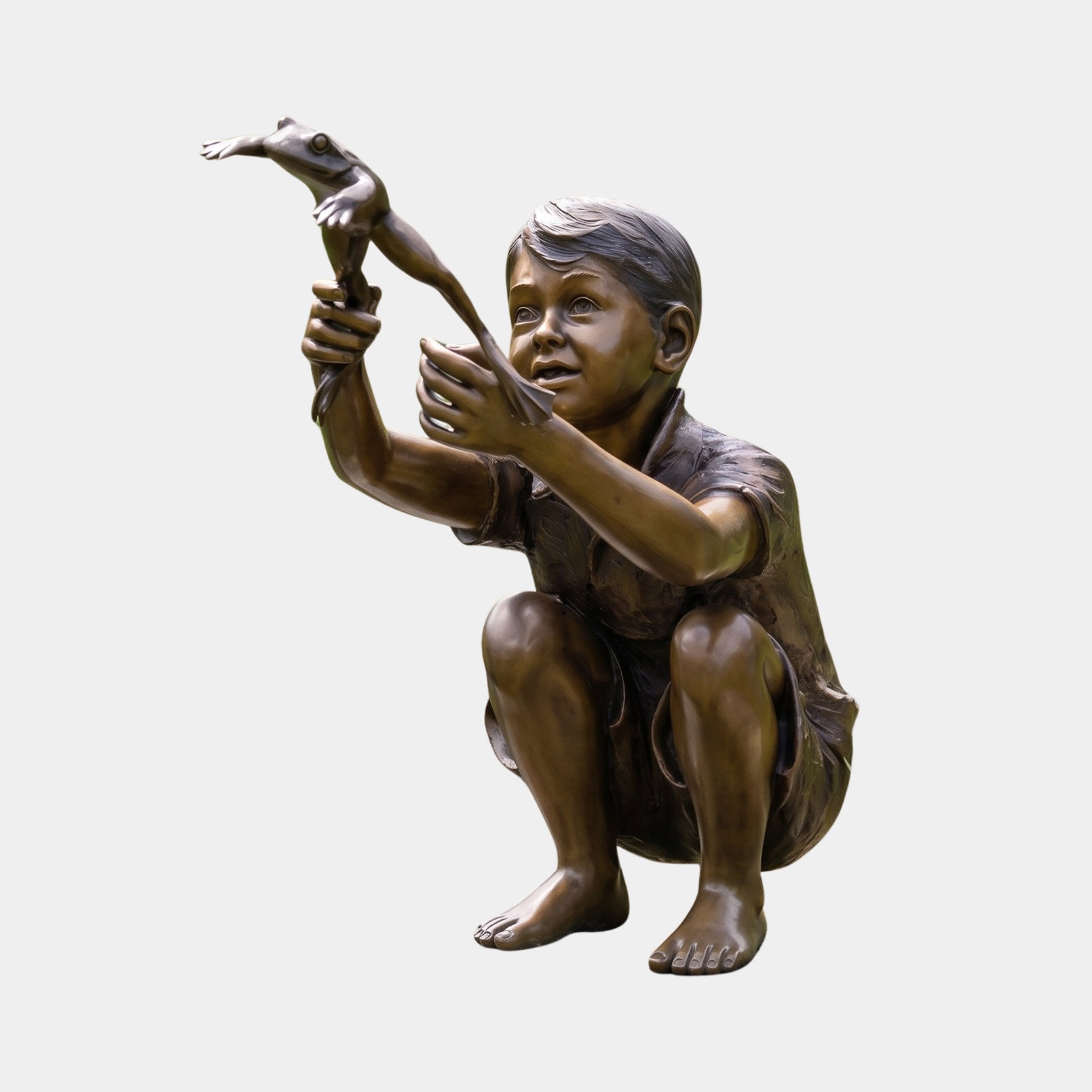 Giant Sculptures Life-Size Boy with Jumping Frog Bronze Sculpture, 120cm, child crouching with arms raised holding a leaping frog, warm patina, plain background.