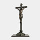 Life-Size Classical Crucifixion of Christ Bronze Sculpture by Giant Sculptures, dark patinated figure on a rugged cross with rocky base, plain white background.