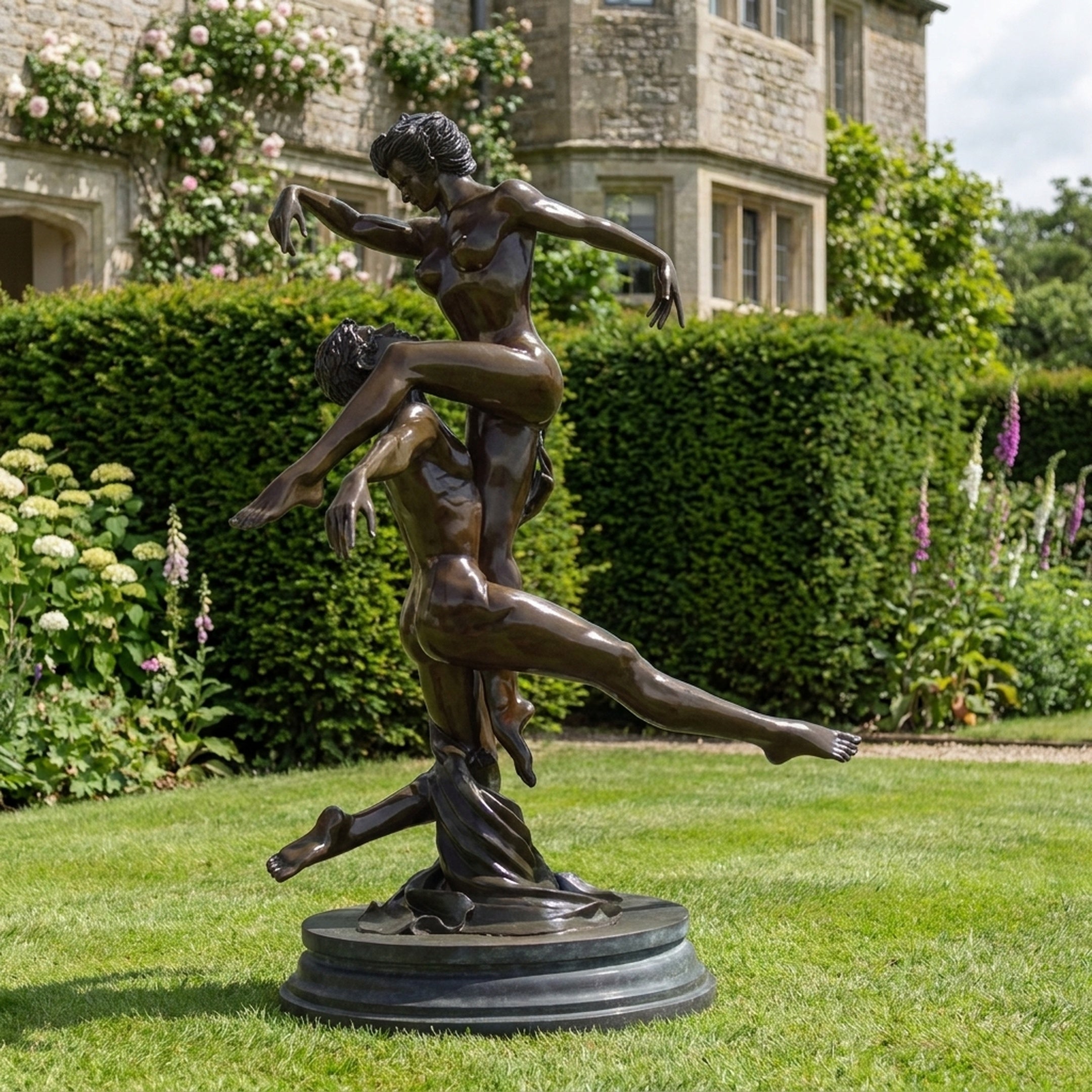 Life-Size Classical Nude Dancer Couple Bronze Sculpture by Giant Sculptures, male lifting female overhead in arched pose, displayed on lawn before a manor.
