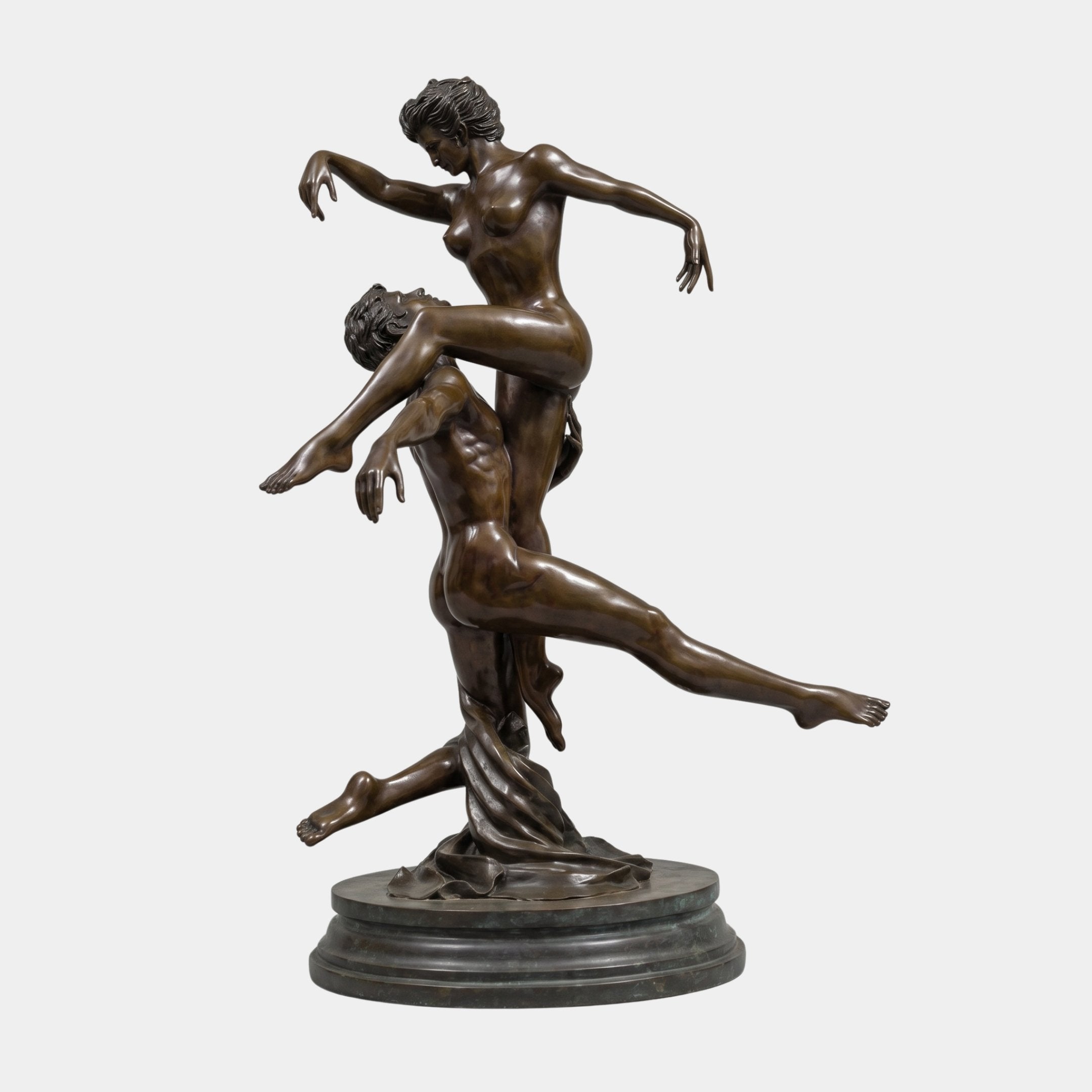 Life-Size Classical Nude Dancer Couple Bronze Sculpture by Giant Sculptures, male figure lifting an arching female partner overhead, on a circular plinth.