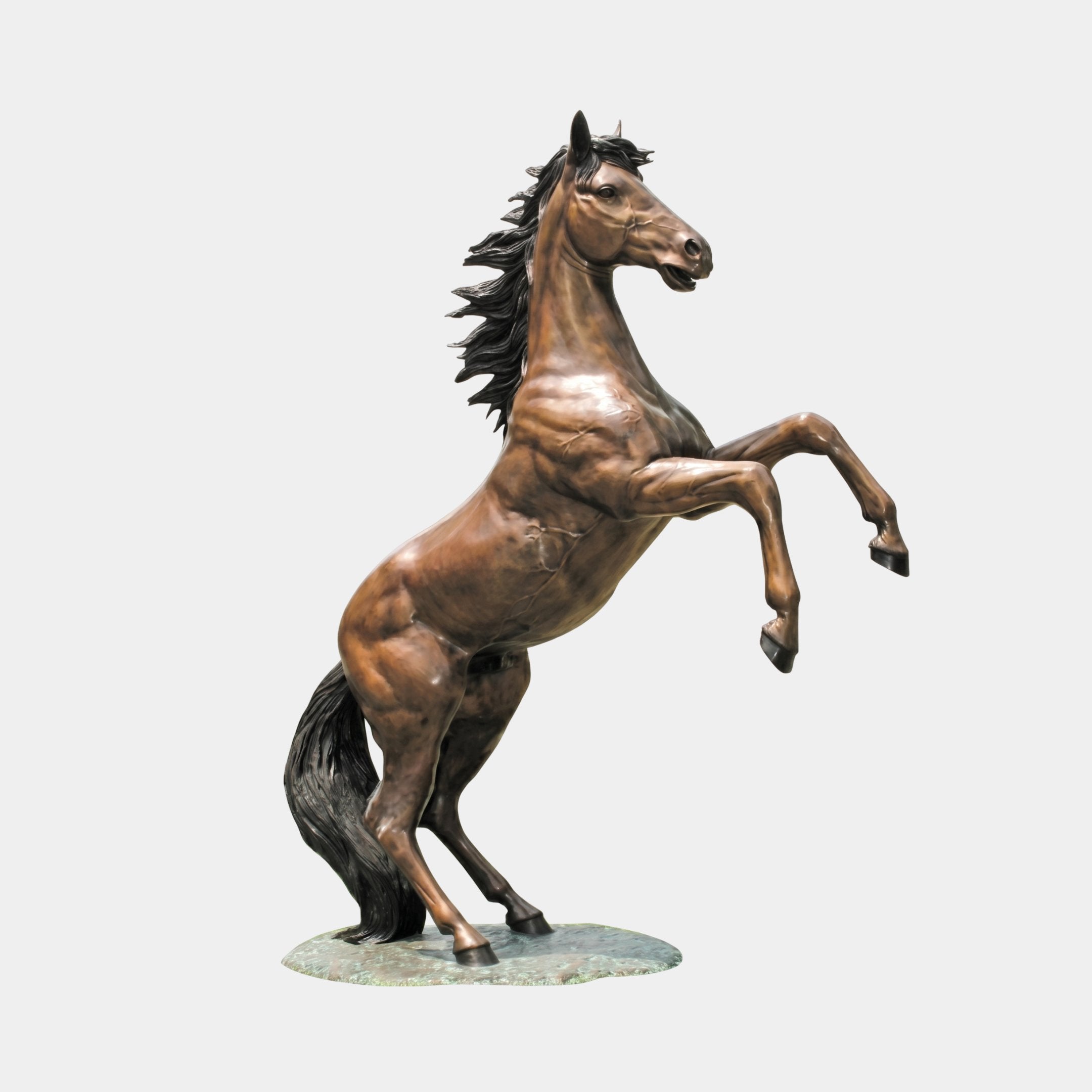 Life-Size Classical Rearing Horse Bronze Sculpture by Giant Sculptures, shown rearing on hind legs with flowing dark mane and tail, warm brown patina, on a textured oval base against a plain light background.