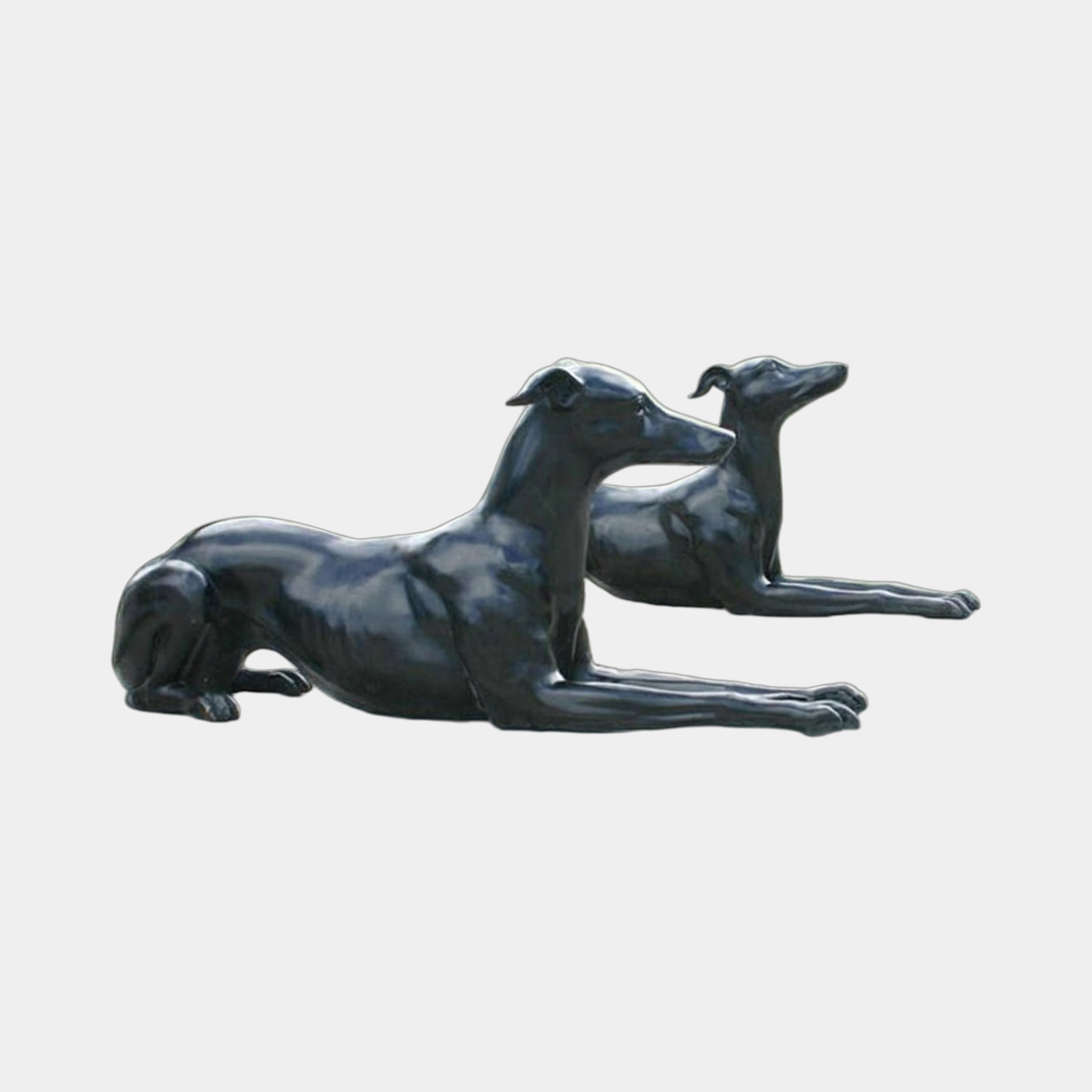 Life-Size Classical Recumbent Greyhound Pair Bronze Sculpture by Giant Sculptures, two black-patinated dogs lying alert in opposite directions on a plain background.
