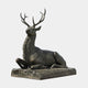 Life-Size Classical Recumbent Stag Bronze Sculpture by Giant Sculptures, shown in side view with antlers raised and legs tucked, in dark patina on a plain background.