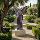 Life-Size Classical Standing Angel Bronze Sculpture by Giant Sculptures, 220cm, wings spread wide, on a stone plinth in a formal Mediterranean garden.