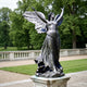 Life-Size Classical Winged Angel Bronze Statue by Giant Sculptures, arms raised with spread feathered wings, dark patina finish, on a stone plinth in a garden.