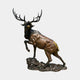 Life-Size Contemporary Bugling Elk Bronze Sculpture by Giant Sculptures, shown mid-bugle with raised front leg, multi-tone amber and black patina, on a rocky base.
