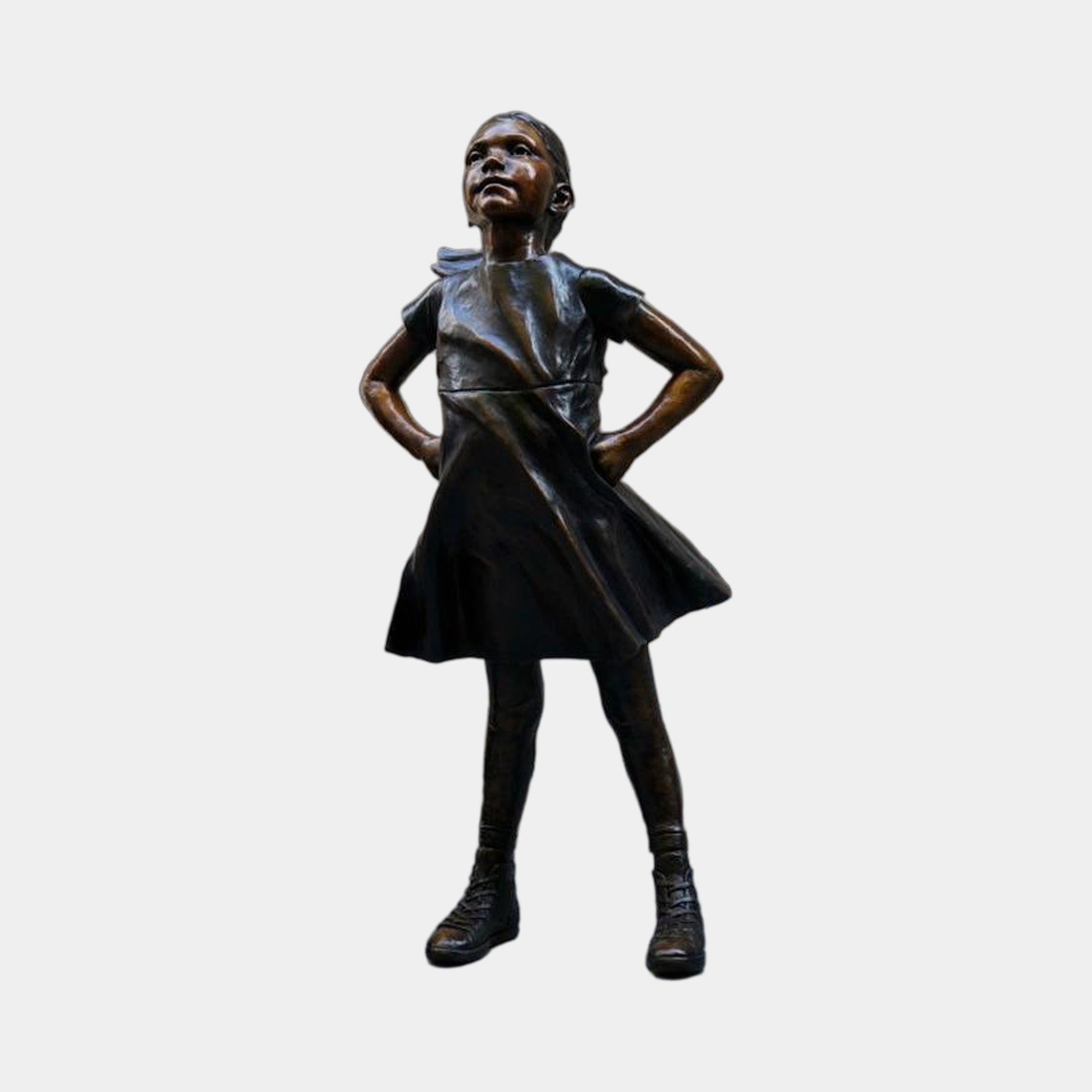 Life-Size Contemporary Defiant Girl Bronze Sculpture by Giant Sculptures, 130cm, hands on hips with chin raised, dark brown patina, plain light background.