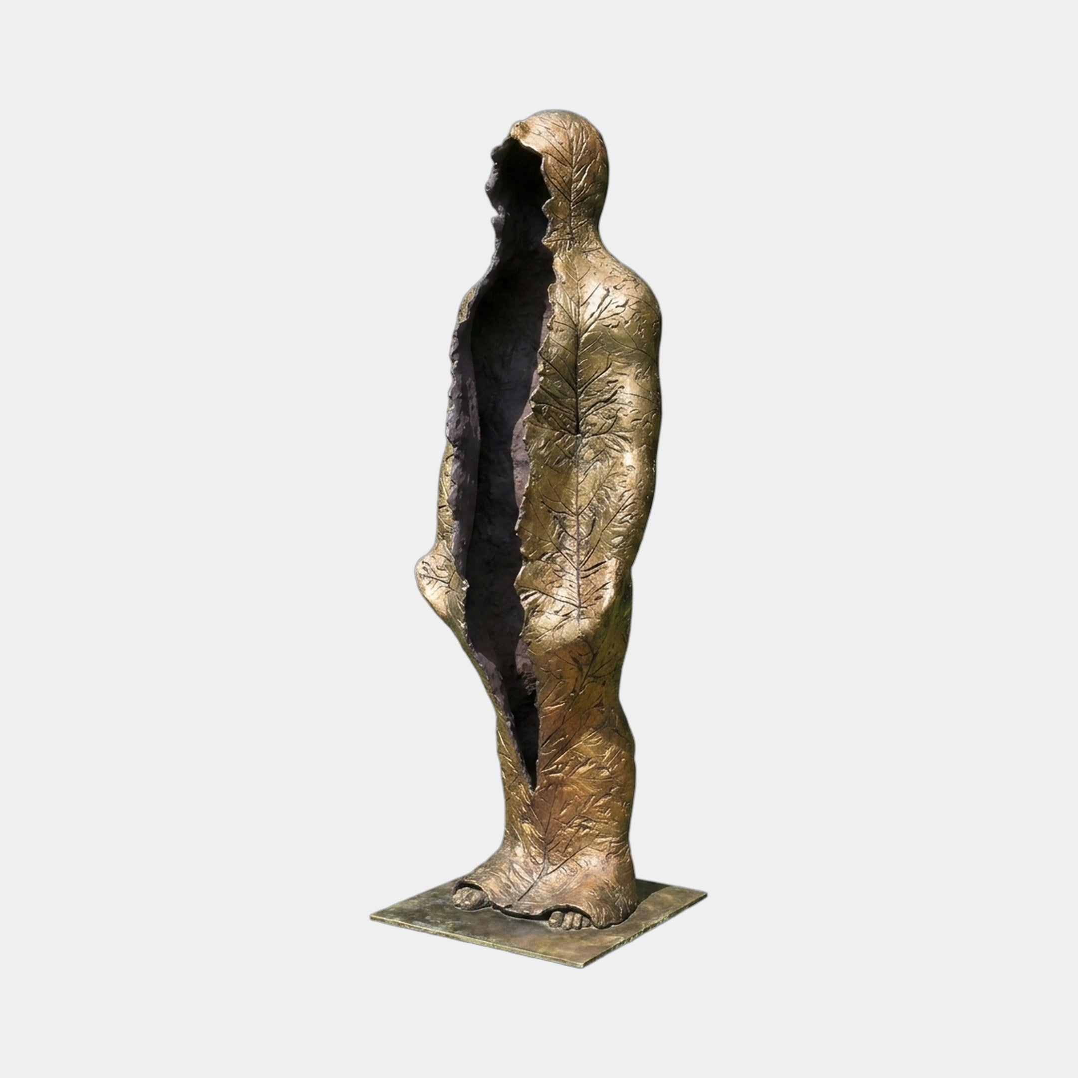 Life-Size Contemporary Emerging Figures Bronze Sculpture by Giant Sculptures, standing figure with leaf-veined golden patina and vertical split revealing dark hollow interior.