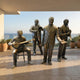 Life-Size Contemporary Jazz Band Bronze Sculpture by Giant Sculptures, featuring a seated banjo player, trombonist, singer, and clarinetist on an ocean-view terrace.