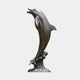 Life-Size Contemporary Leaping Dolphin Bronze Sculpture, 250cm, arched mid-leap on a coral and wave-form base, warm bronze patina, plain light grey background.