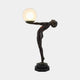 Giant Sculptures Life-Size Contemporary Nude Female Figure Bronze Sculpture 210cm, leaning forward to hold a frosted glass globe lamp, on a black hexagonal plinth.