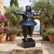 Life-Size Contemporary Rotund Dancer Bronze Sculpture by Giant Sculptures in deep black patina, balanced on one heel with arms outstretched, in a Mediterranean courtyard.