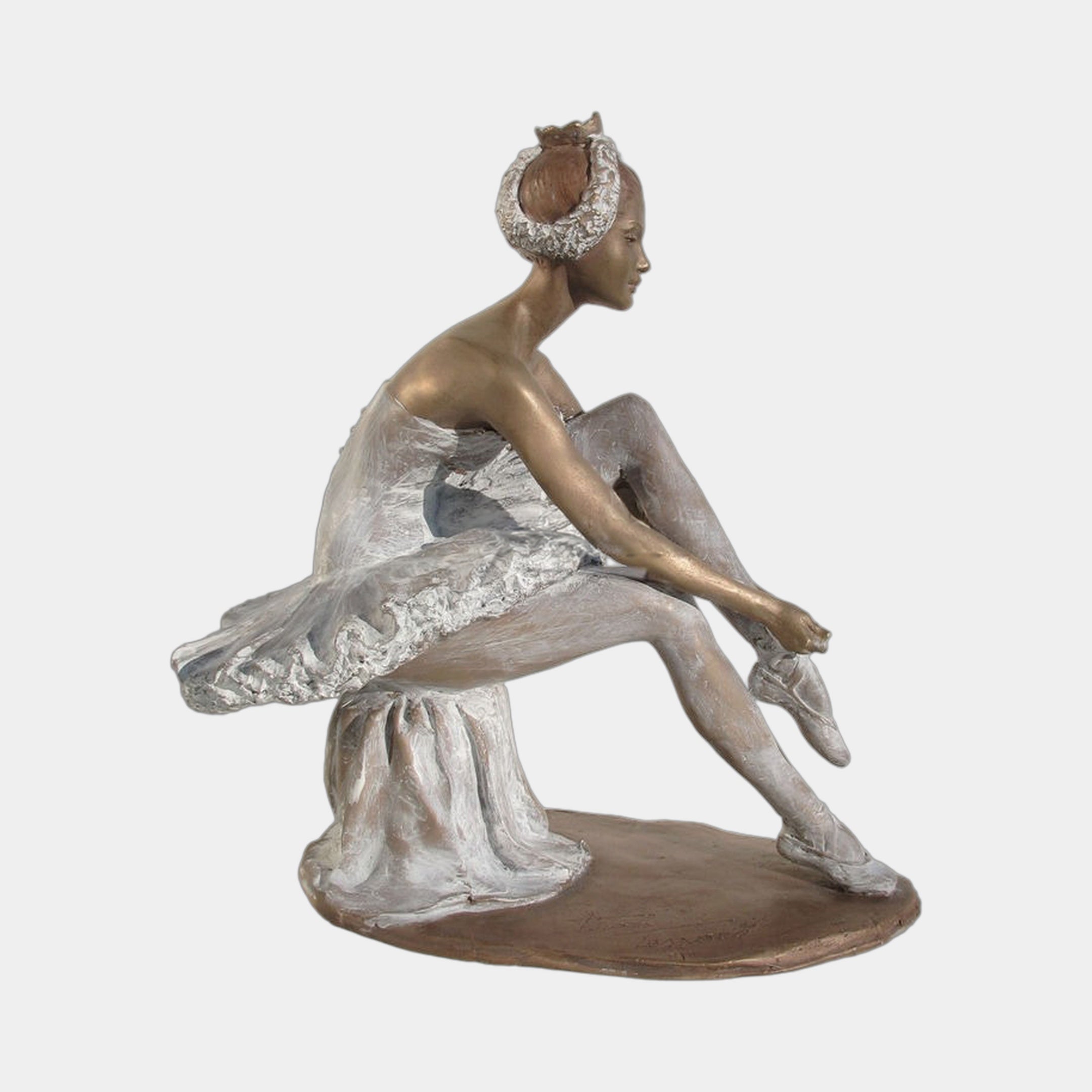 Life-Size Contemporary Seated Ballerina Bronze Sculpture by Giant Sculptures, side view of a seated dancer adjusting her pointe shoe in a white tutu.