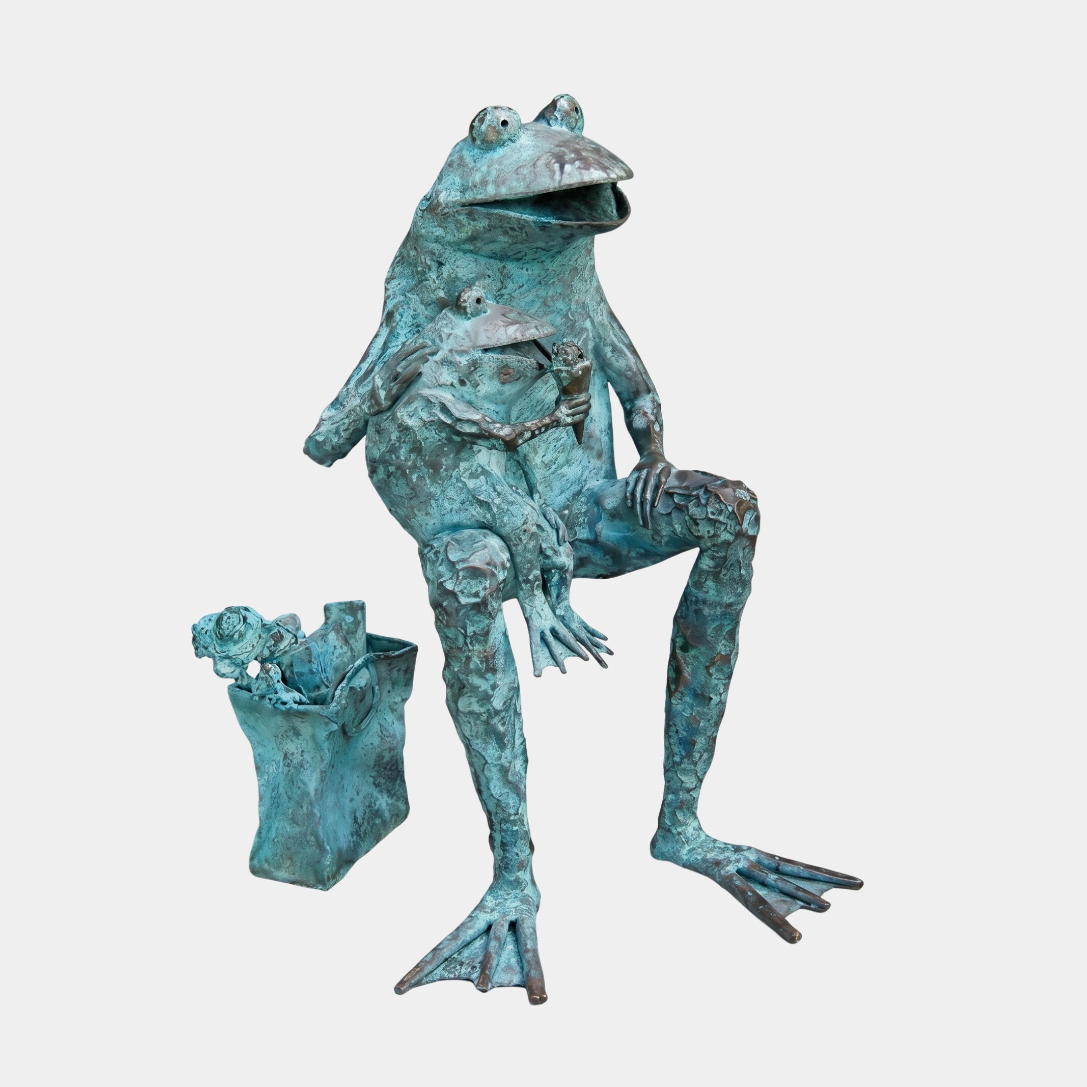 Life-Size Contemporary Seated Frog Bronze Sculpture by Giant Sculptures, shown with verdigris patina, holding a smaller frog and a bag of frogs at its feet.