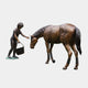 Life-Size Girl Feeding Horse Bronze Sculpture by Giant Sculptures, 170cm, showing the girl with bucket extending her hand to the horse's lowered head.