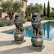 Giant Sculptures Life-Size Heraldic Roaring Lions Bronze Sculpture Pair in dark antique patina, paws on decorative spheres, flanking a poolside terrace.