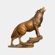 Life-Size Howling Wolf Bronze Sculpture by Giant Sculptures, 220cm, shown in side profile with front paws on a rocky ledge and head raised mid-howl.