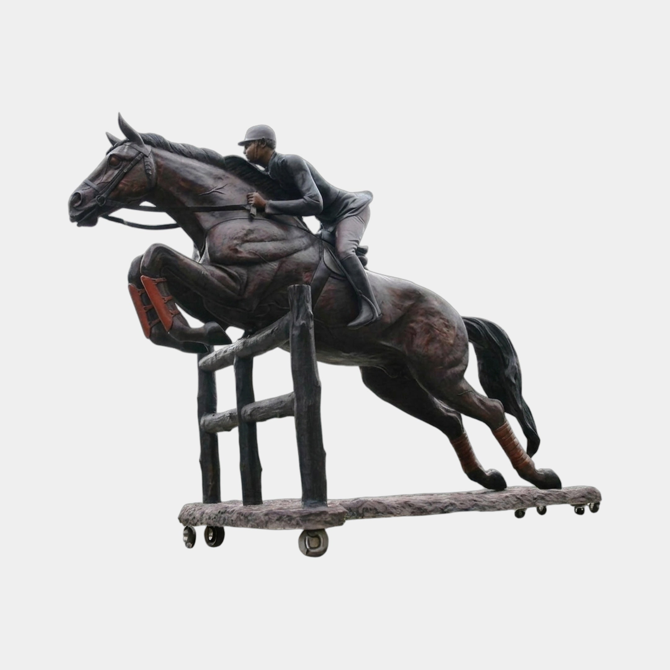 Giant Sculptures Life-Size Jockey and Horse Clearing a Jump Bronze Sculpture 330cm, dark patina with reddish hooves, mid-leap over fence on castor base.
