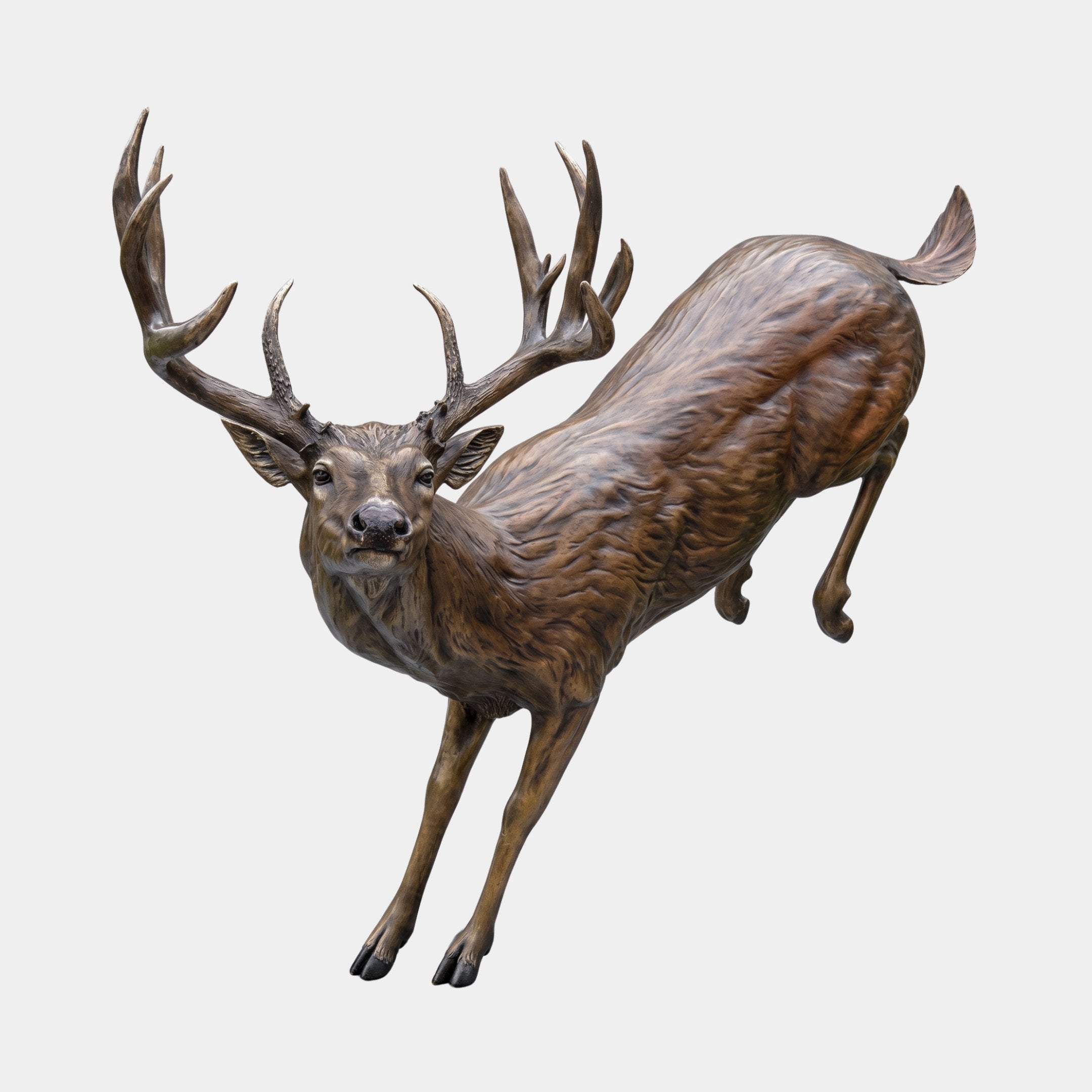 Life-Size Leaping Whitetail Buck Bronze Sculpture by Giant Sculptures, shown mid-leap with wide multi-point antlers and warm brown patina on a plain background.