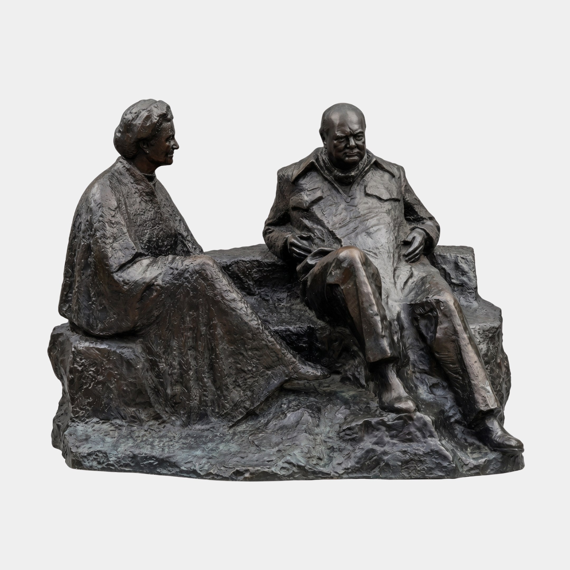 Life-Size Seated Conversing Figures Bronze Sculpture by Giant Sculptures, 220cm, showing two adults on a rocky base with dark patina against a plain background.