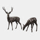 Life-Size Standing Stag and Grazing Doe Bronze Sculpture by Giant Sculptures, shown in dark brown patina with the antlered stag alert and the doe lowered to graze.