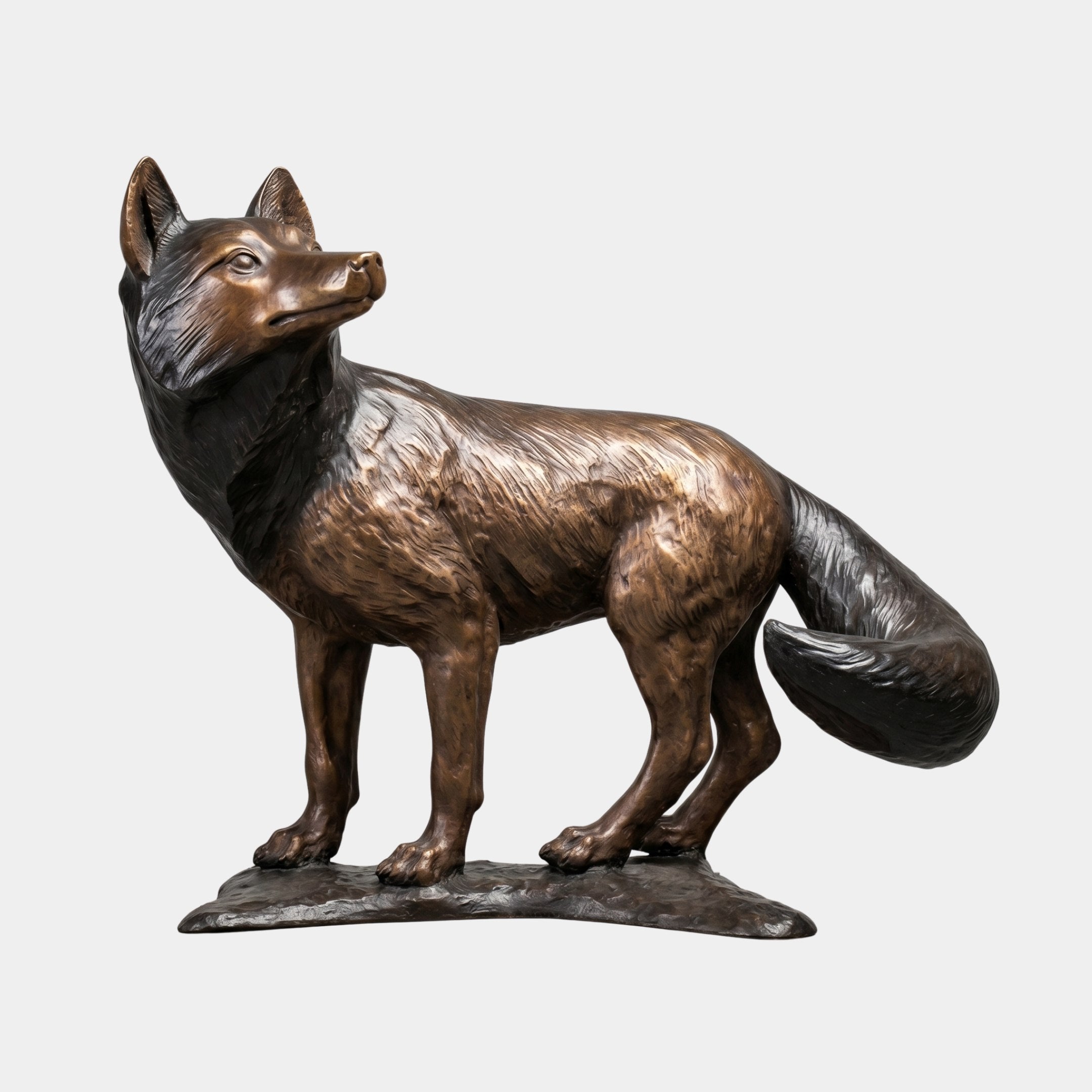 Life-Size Traditional Alert Fox Bronze Sculpture by Giant Sculptures shown in side profile with raised head, two-tone golden-brown and black patina, on a flat bronze base.