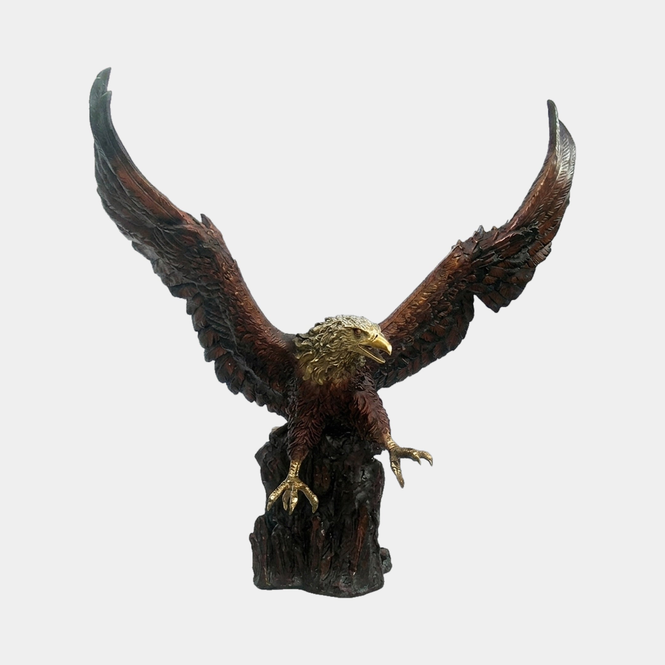 Life-Size Traditional Bald Eagle Bronze Sculpture from Giant Sculptures, wings fully spread upward, golden head and talons, perched on a textured base against white.