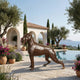 Life-Size Traditional Boxer Dog Bronze Sculpture by Giant Sculptures with dark brown patina, displayed on a Mediterranean poolside terrace overlooking the sea.