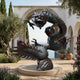 Life-Size Traditional Chinese Dragon Bronze Sculpture by Giant Sculptures, 220cm coiling dragon with two-tone patina, grasping a sphere in a Mediterranean courtyard.