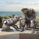 Giant Sculptures Life-Size Traditional Cowboy and Husky Dog Bronze Sculpture 190cm shown on a seaside terrace, with the seated prospector facing his husky.