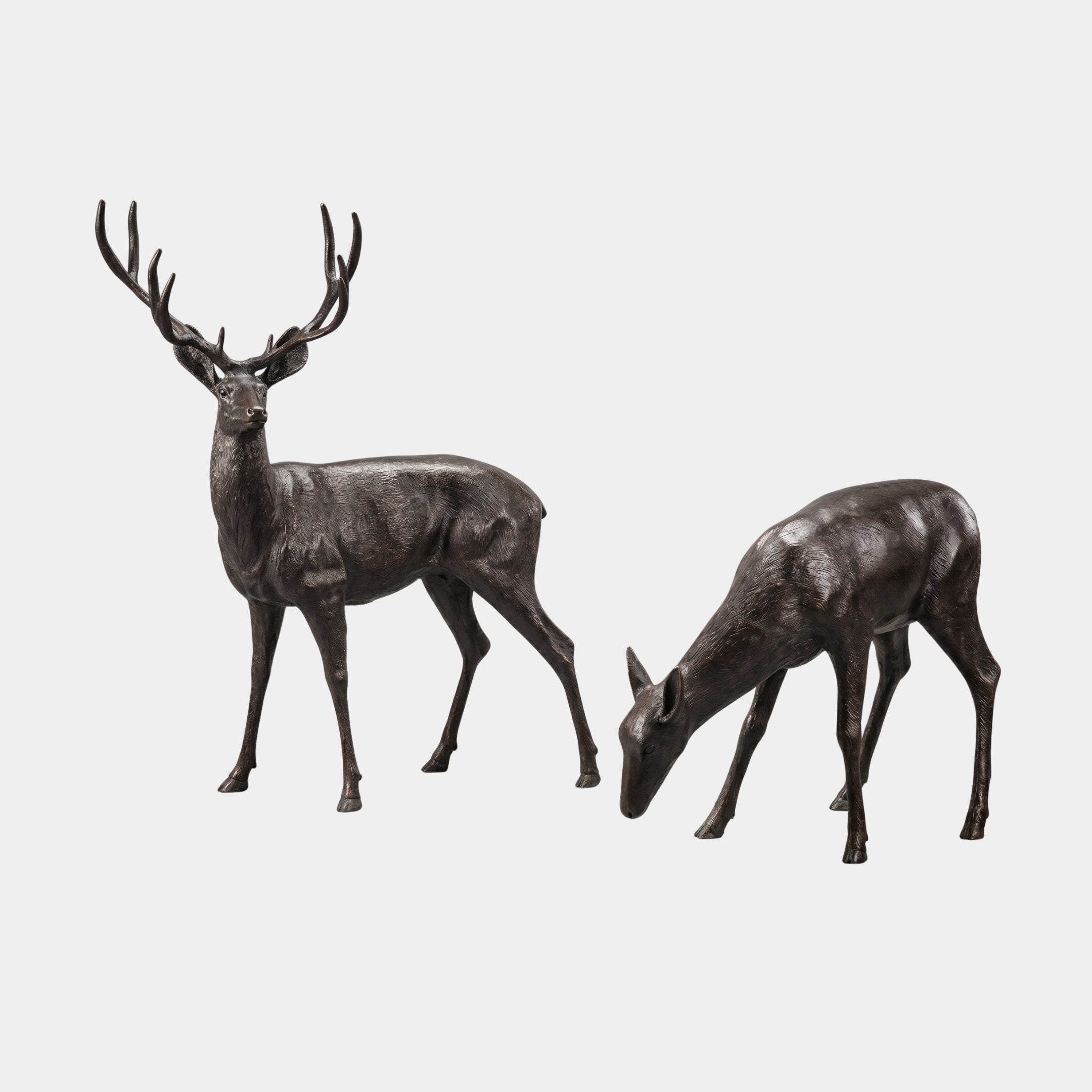 Life-Size Traditional Deer Bronze Sculpture Pair by Giant Sculptures, 170cm, showing an antlered stag standing alert beside a grazing doe in dark patinated bronze.