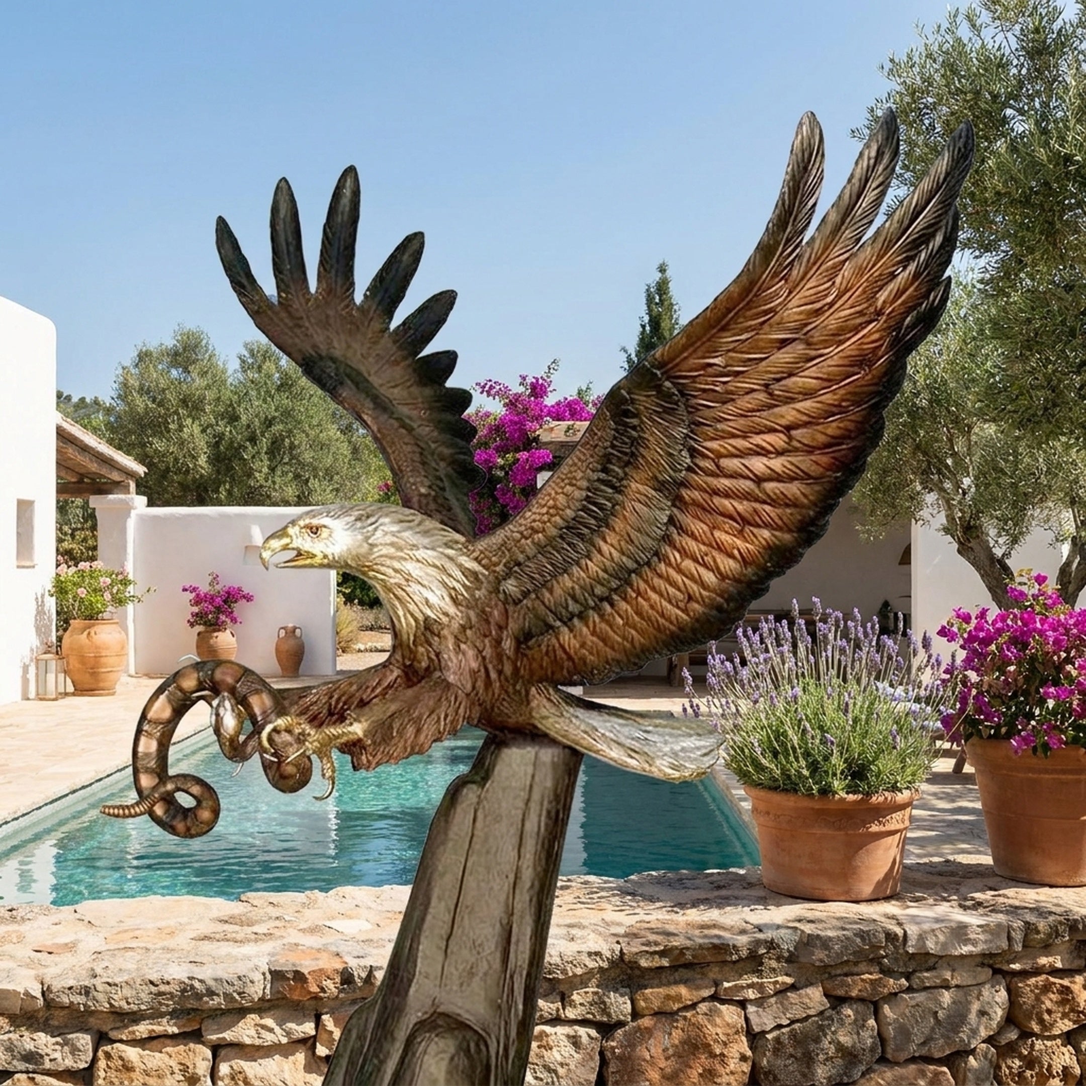 Life-Size Traditional Eagle Bronze Sculpture by Giant Sculptures, wings raised mid-strike with a coiled serpent in its talons, displayed beside a poolside terrace.